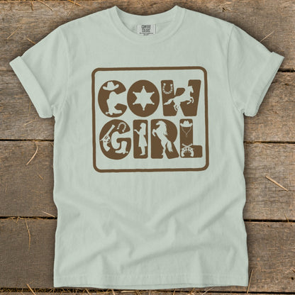 Light blue t-shirt with "COWGIRL" text and cowboy-themed icons in brown.