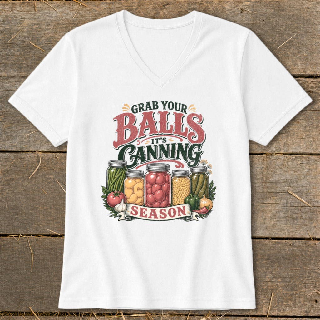 White t-shirt with "Grab Your Balls It's Canning Season" graphic and jars of produce.