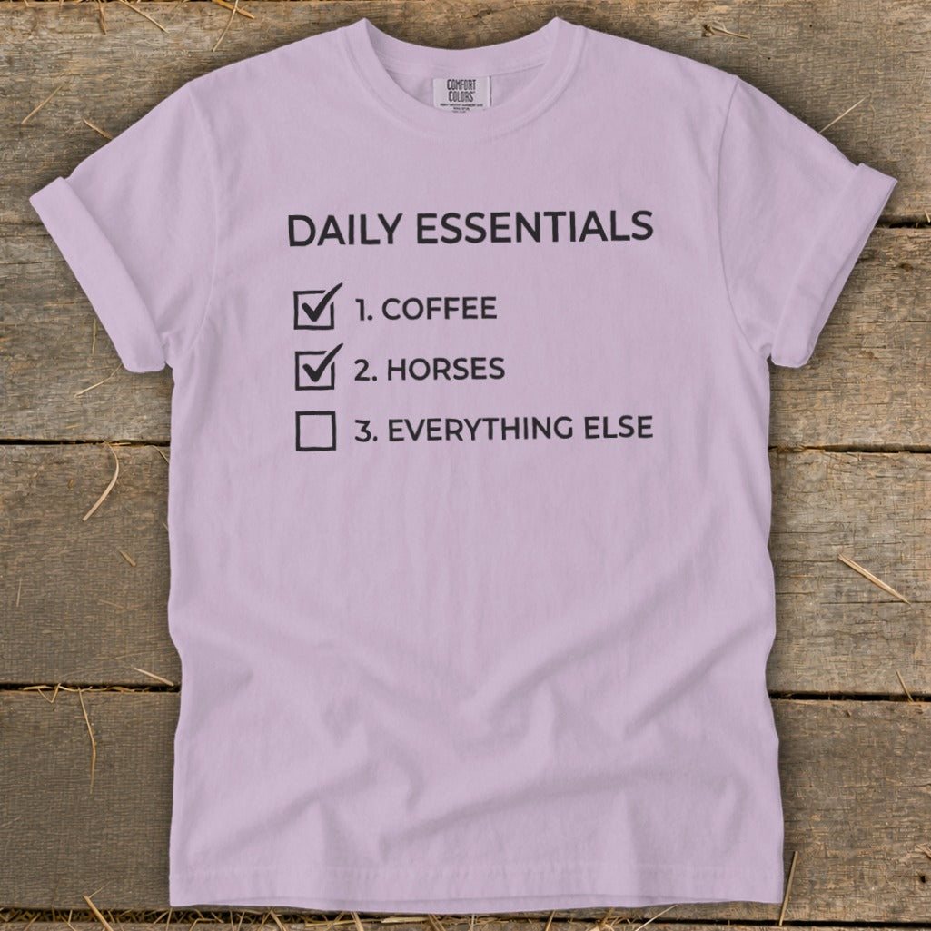 Lilac t-shirt with "Daily Essentials: 1. Coffee, 2. Horses, 3. Everything else" text.