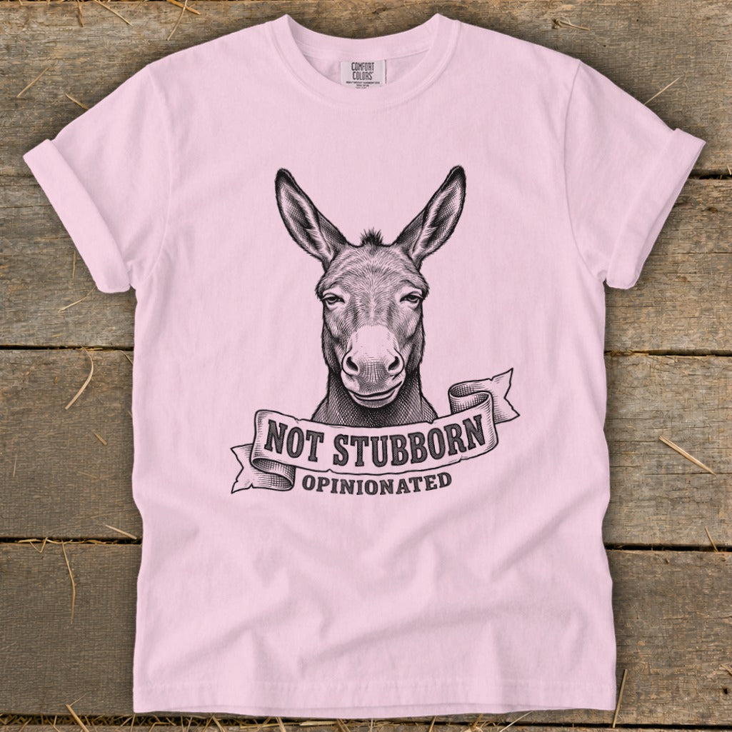 Pink t-shirt with sketch of donkey head and text "Not Stubborn, Opinionated".