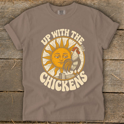 Brown t-shirt featuring a sun graphic, a crowing rooster, and the text Up With The Chickens.
