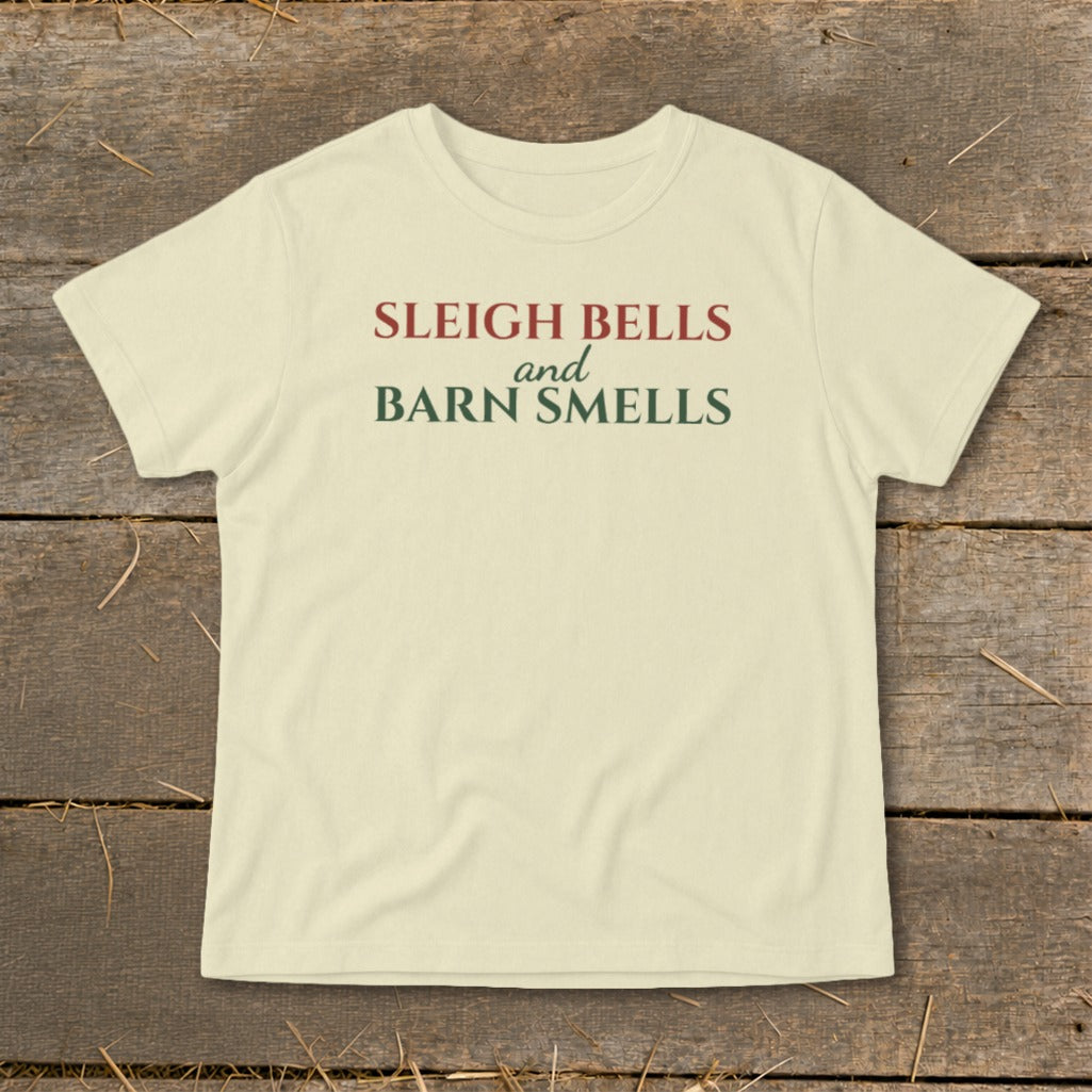 Light yellow t-shirt with "Sleigh Bells and Barn Smells" text in red and green.