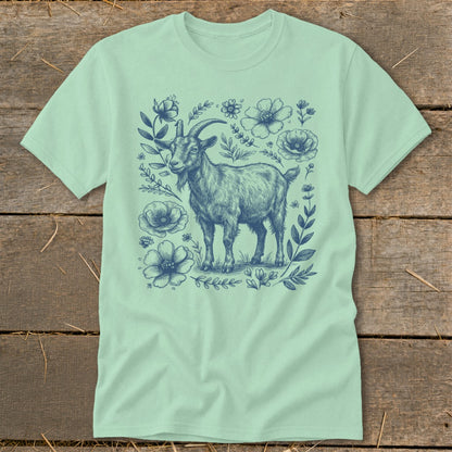 Mint t-shirt with blue sketch of a goat surrounded by flowers.