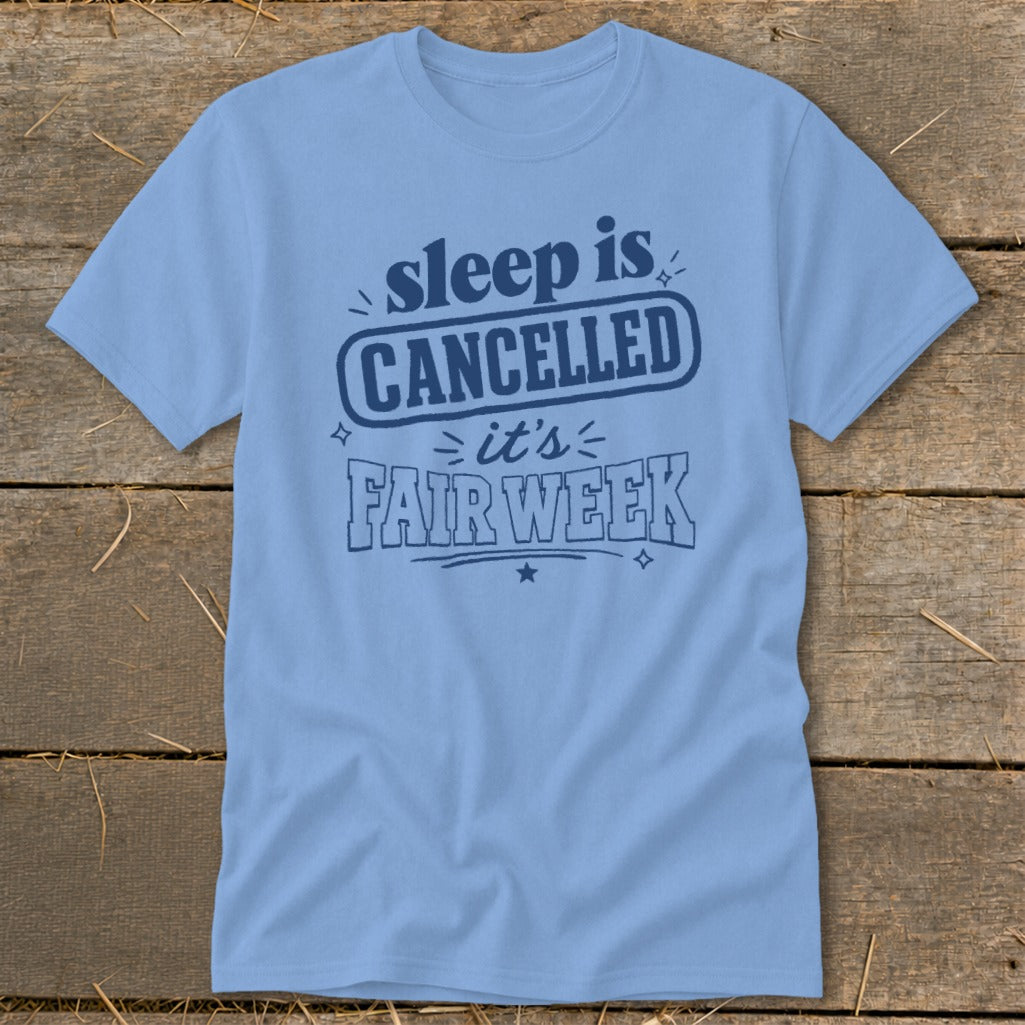 Light blue t-shirt with dark blue text: "sleep is CANCELLED it's FAIR WEEK"