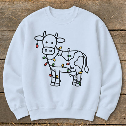 White crewneck sweatshirt with a black outline drawing of a cow decorated with colorful Christmas lights.
