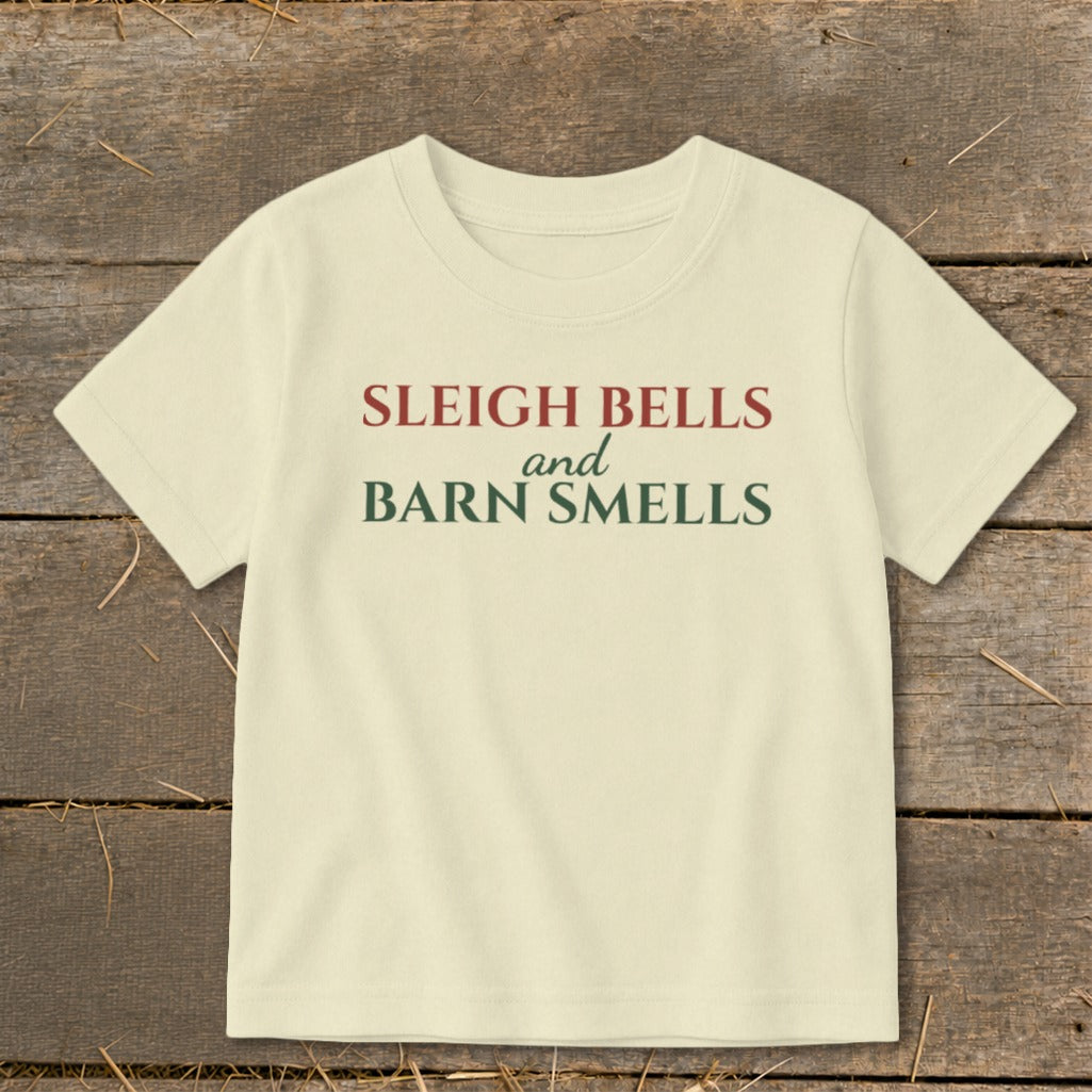 Cream t-shirt with "SLEIGH BELLS and BARN SMELLS" text in maroon and green.