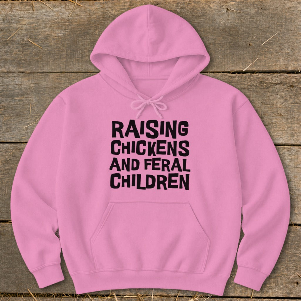 Pink hoodie with black text reading "Raising Chickens and Feral Children".