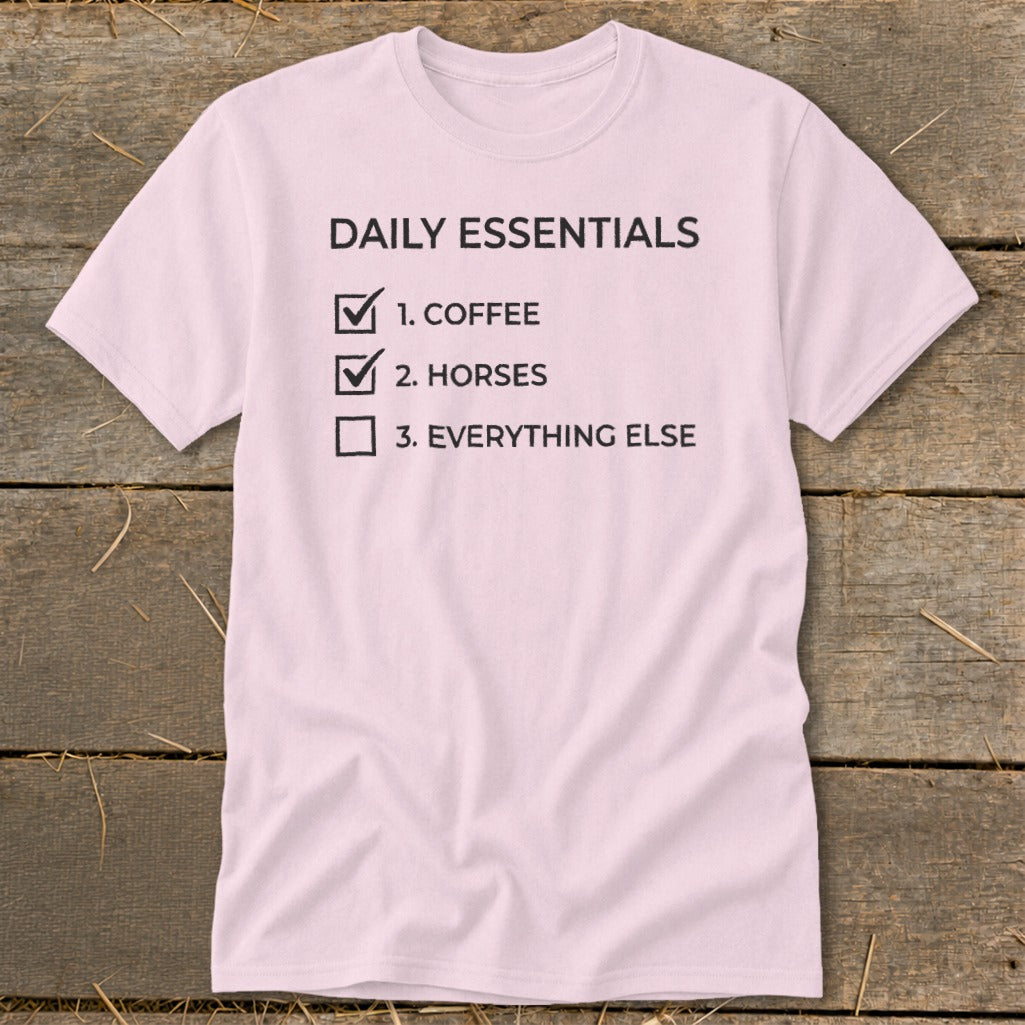 Pink t-shirt with "Daily Essentials" list: 1. Coffee, 2. Horses, 3. Everything Else.