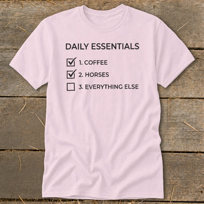 Pink t-shirt with "Daily Essentials" list: 1. Coffee, 2. Horses, 3. Everything Else.