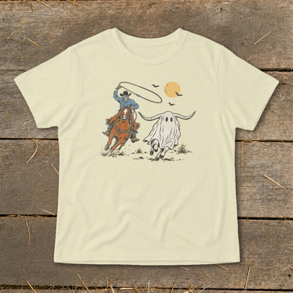 Cowboy lassoing a ghost with longhorns under a setting sun.