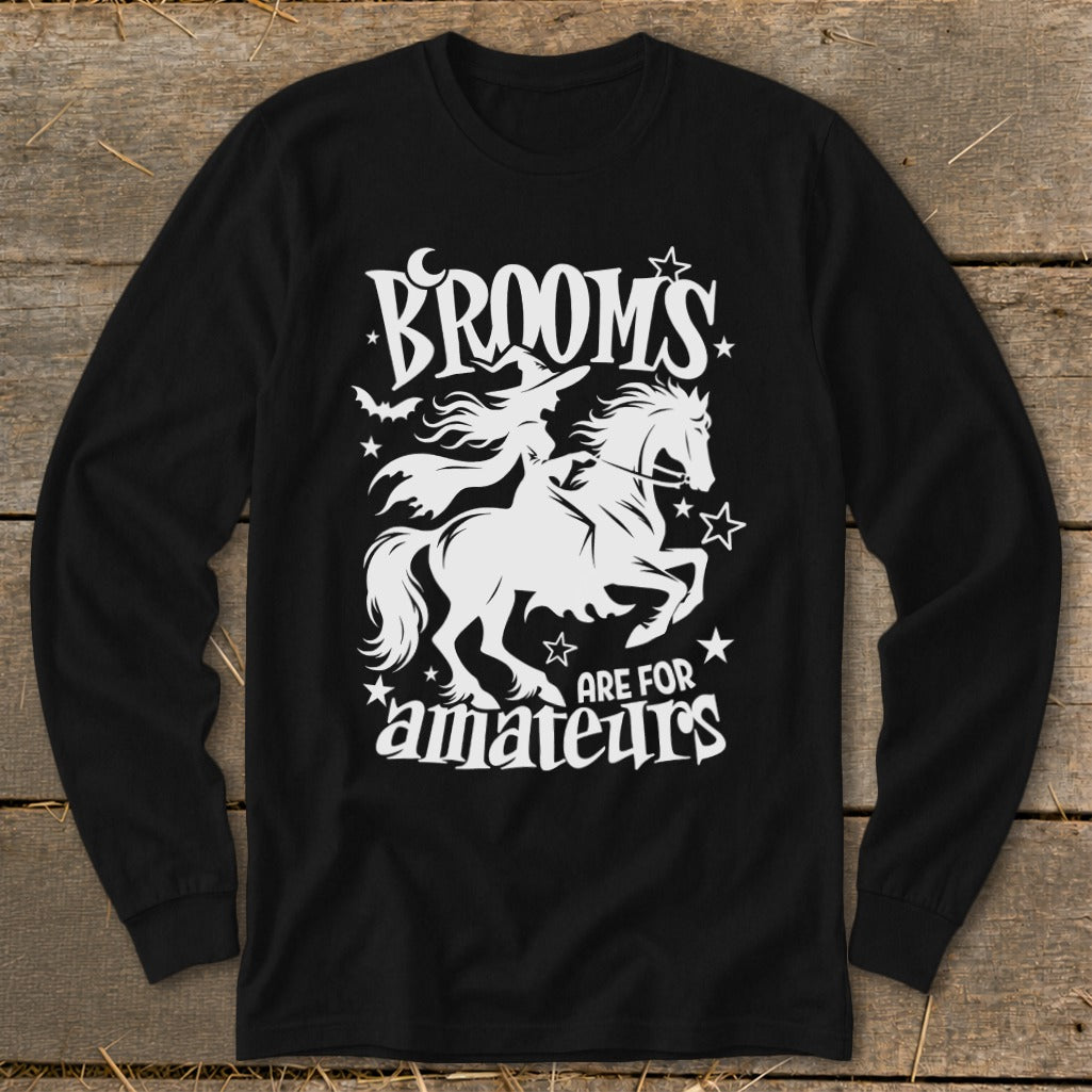 Black long-sleeve shirt with white graphic: witch on horse, text "Brooms are for amateurs."