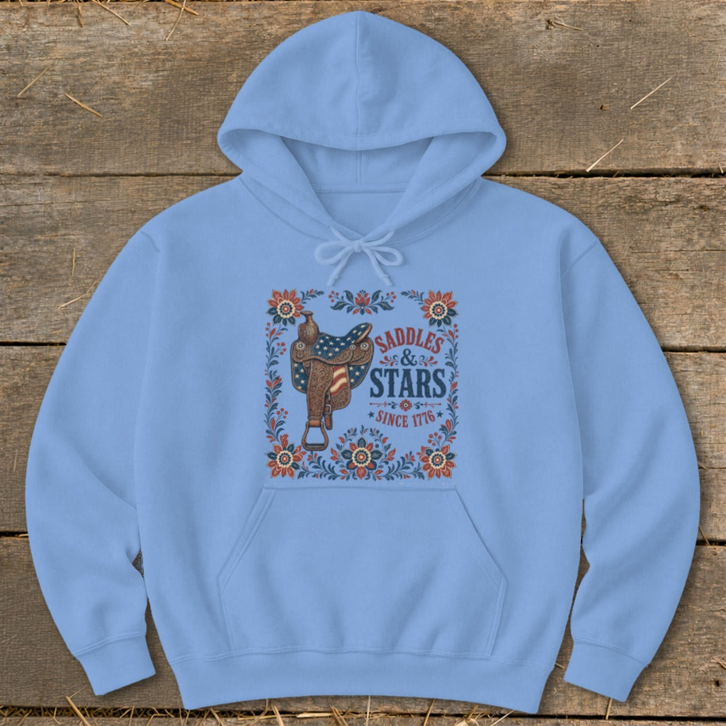 Light blue hoodie with a saddle, stars, and flowers graphic reading "Saddles & Stars Since 1776."