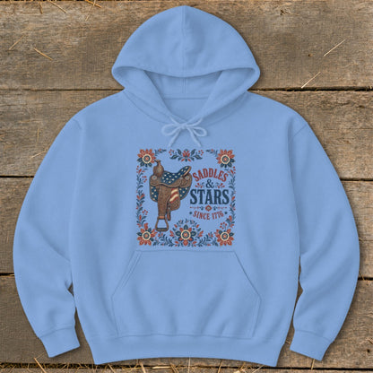 Light blue hoodie with a saddle, stars, and flowers graphic reading "Saddles & Stars Since 1776."