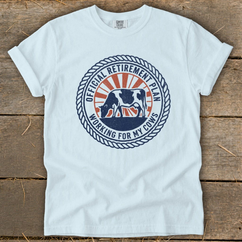 White t-shirt with a circular graphic featuring a cow and text about a retirement plan.