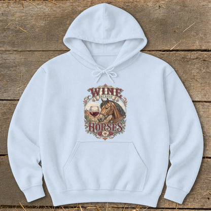 Light blue hoodie with "Wine Because Horses" graphic featuring a horse, wine glass, and desert landscape.