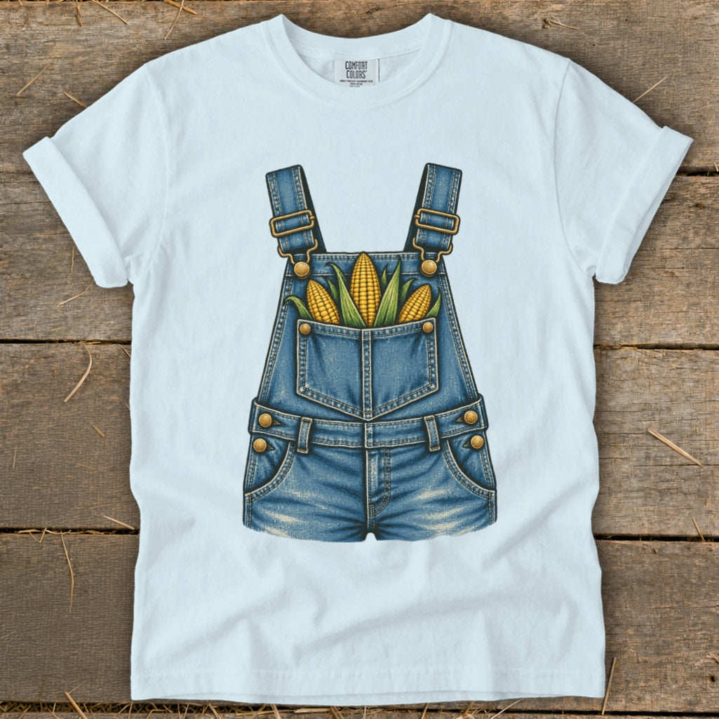 White t-shirt with denim overalls graphic featuring corn in the pocket.