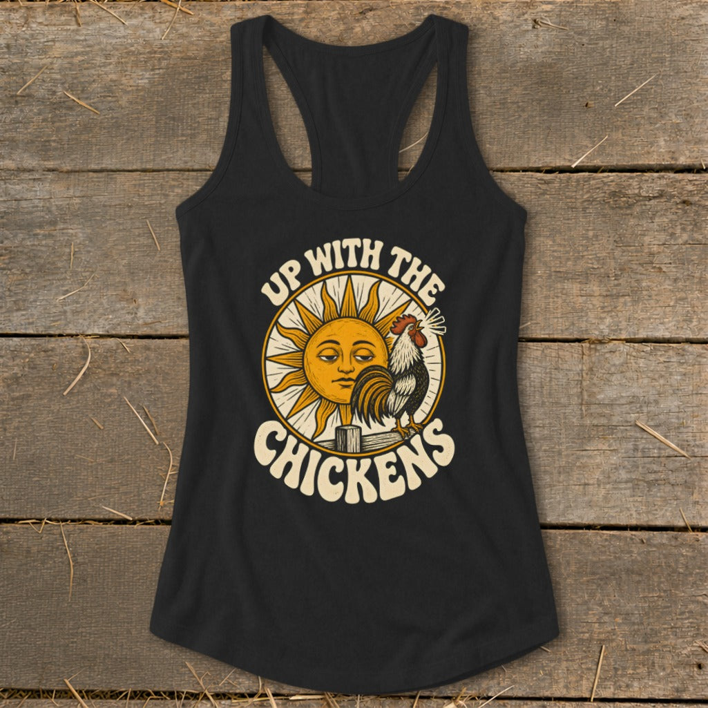 Black racerback tank top featuring a graphic of a rooster crowing before a sun, with text reading Up With The Chickens.