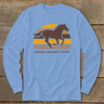 Blue long-sleeve shirt with a brown horse silhouette and "DOING COWBOY STUFF" text.