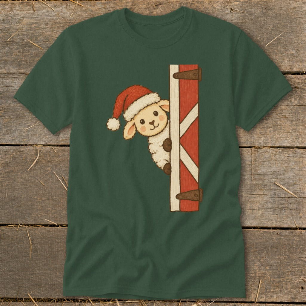 Green t-shirt with a fluffy sheep wearing a Santa hat peeking from behind a red barn door.