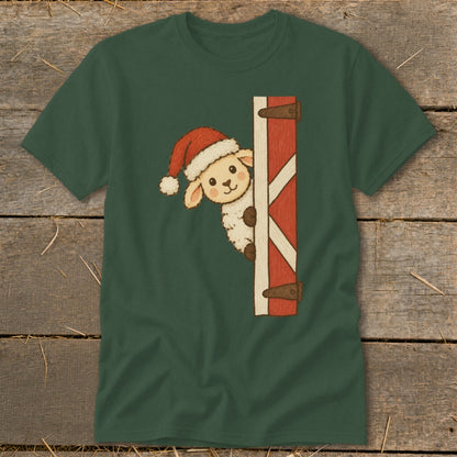 Green t-shirt with a fluffy sheep wearing a Santa hat peeking from behind a red barn door.