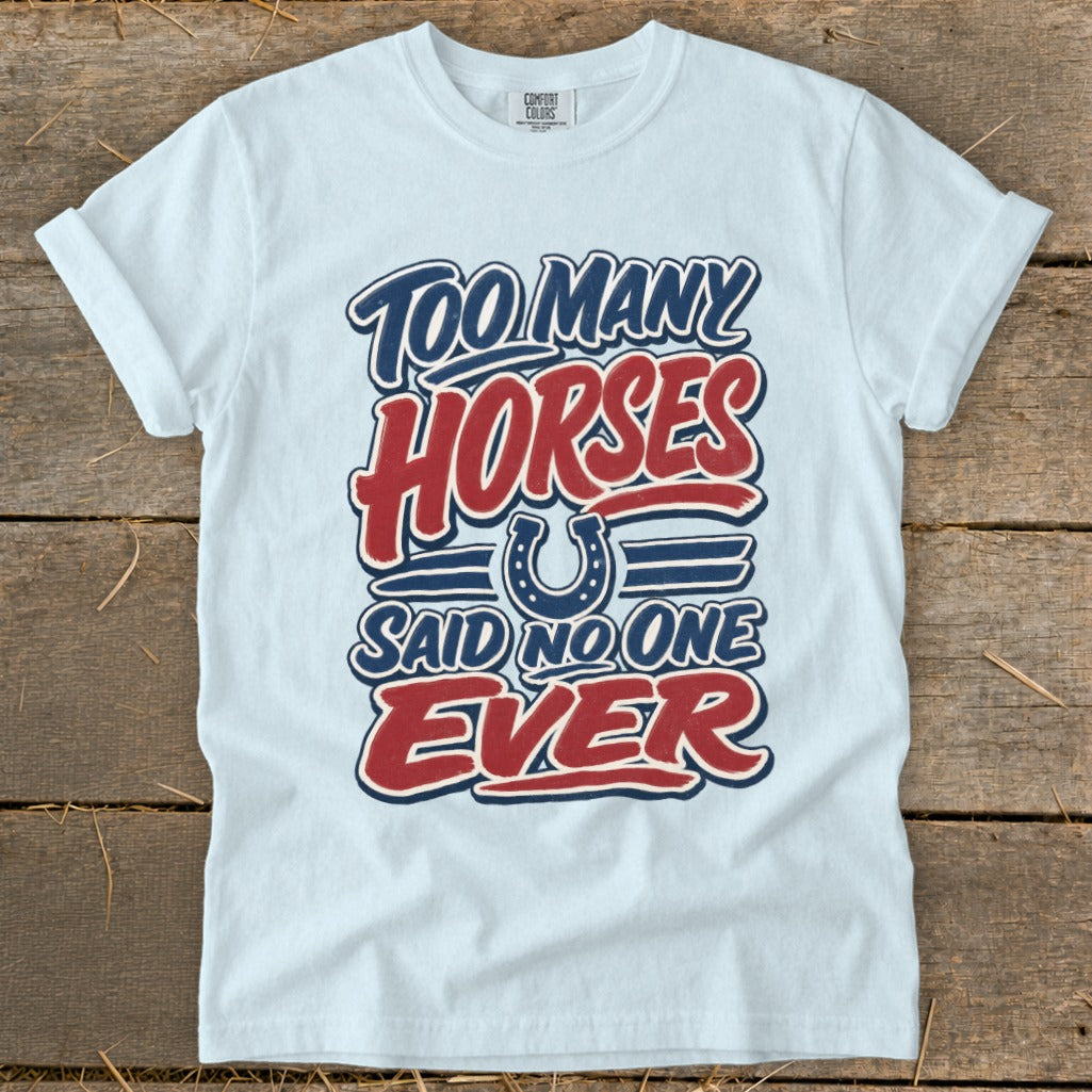 White t-shirt with text "Too many horses said no one ever" and a horseshoe graphic.