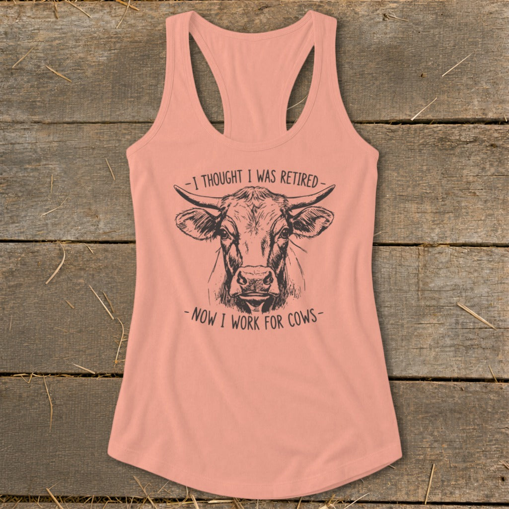 Pink tank top with cow graphic and text "I thought I was retired - now I work for cows".