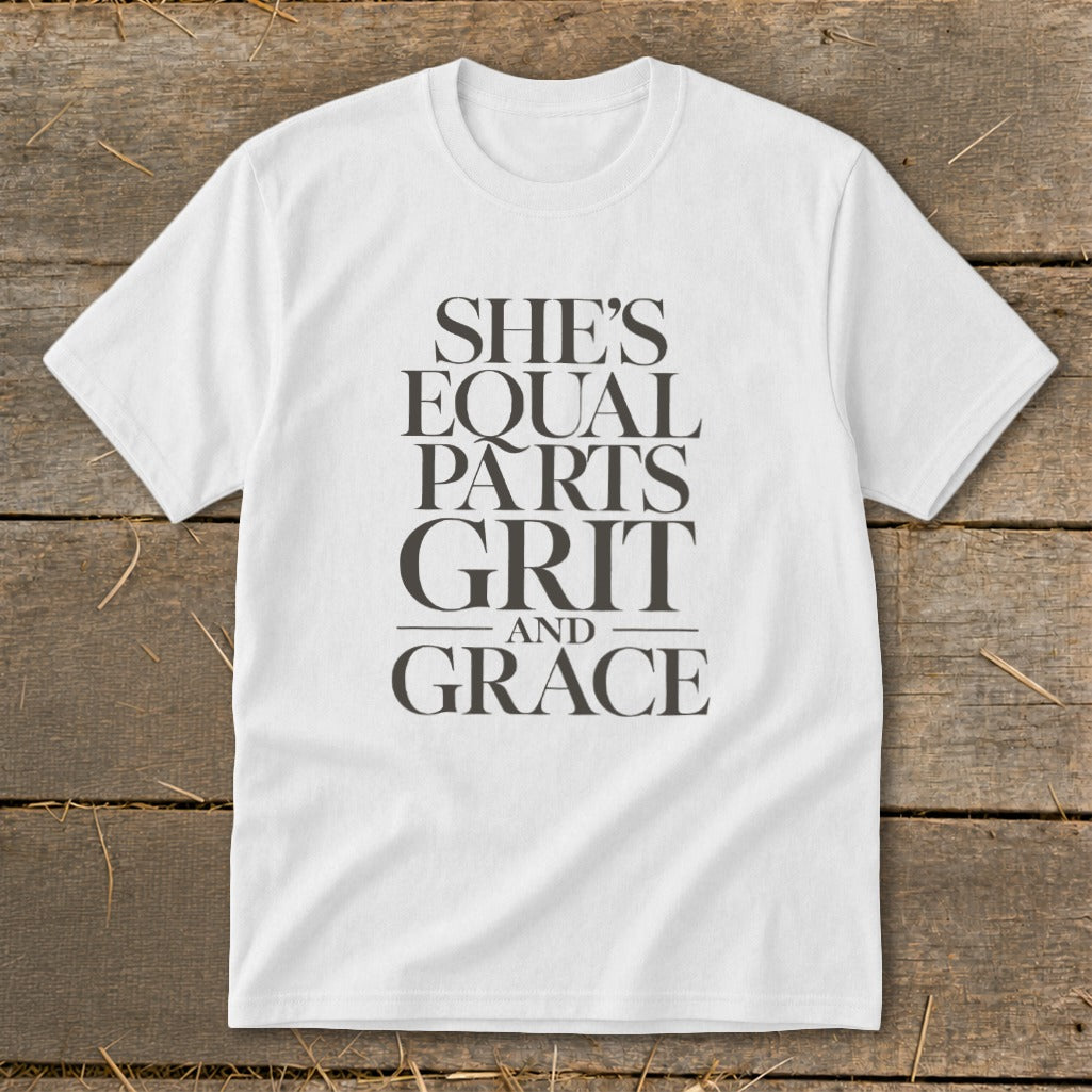 White t-shirt with "SHE'S EQUAL PARTS GRIT AND GRACE" text in dark grey.