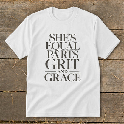 White t-shirt with "SHE'S EQUAL PARTS GRIT AND GRACE" text in dark grey.