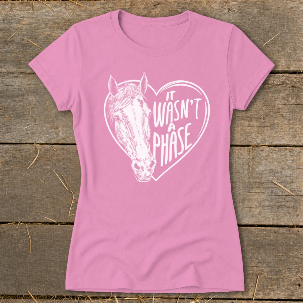 Pink t-shirt with white horse head inside a heart that reads "it wasn't a phase".
