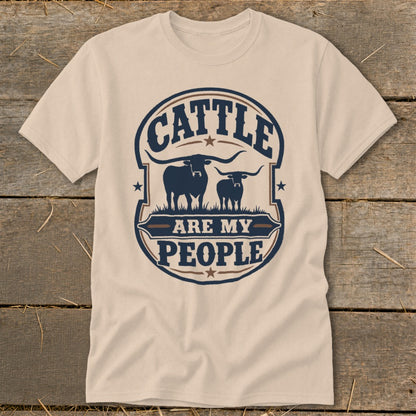Cream t-shirt with "Cattle Are My People" text and two longhorn silhouettes.