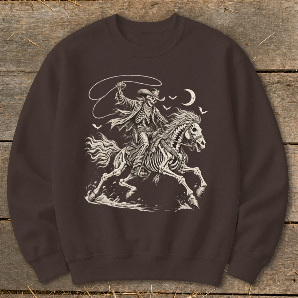 Skeleton cowboy on horseback with lasso, bats and moon graphic on a dark brown sweatshirt.