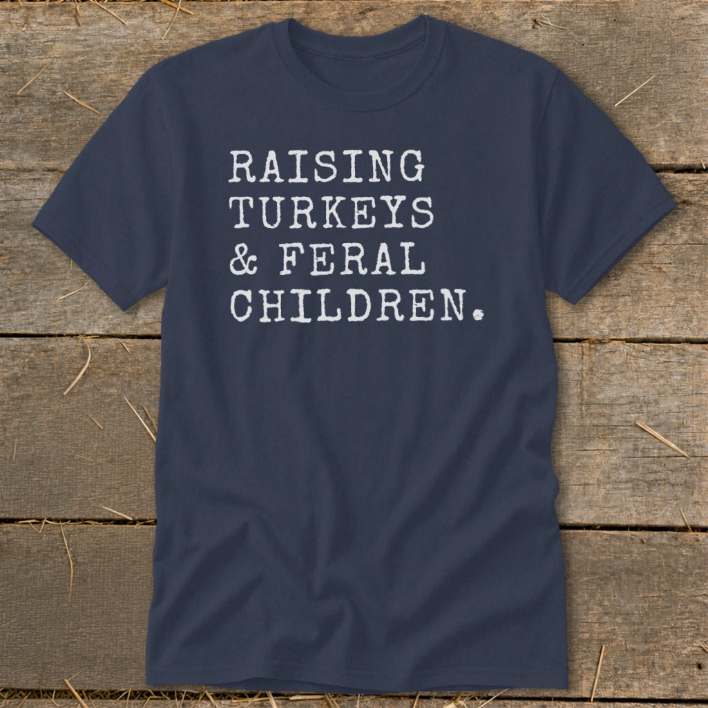 Navy t-shirt with white text: "RAISING TURKEYS & FERAL CHILDREN."