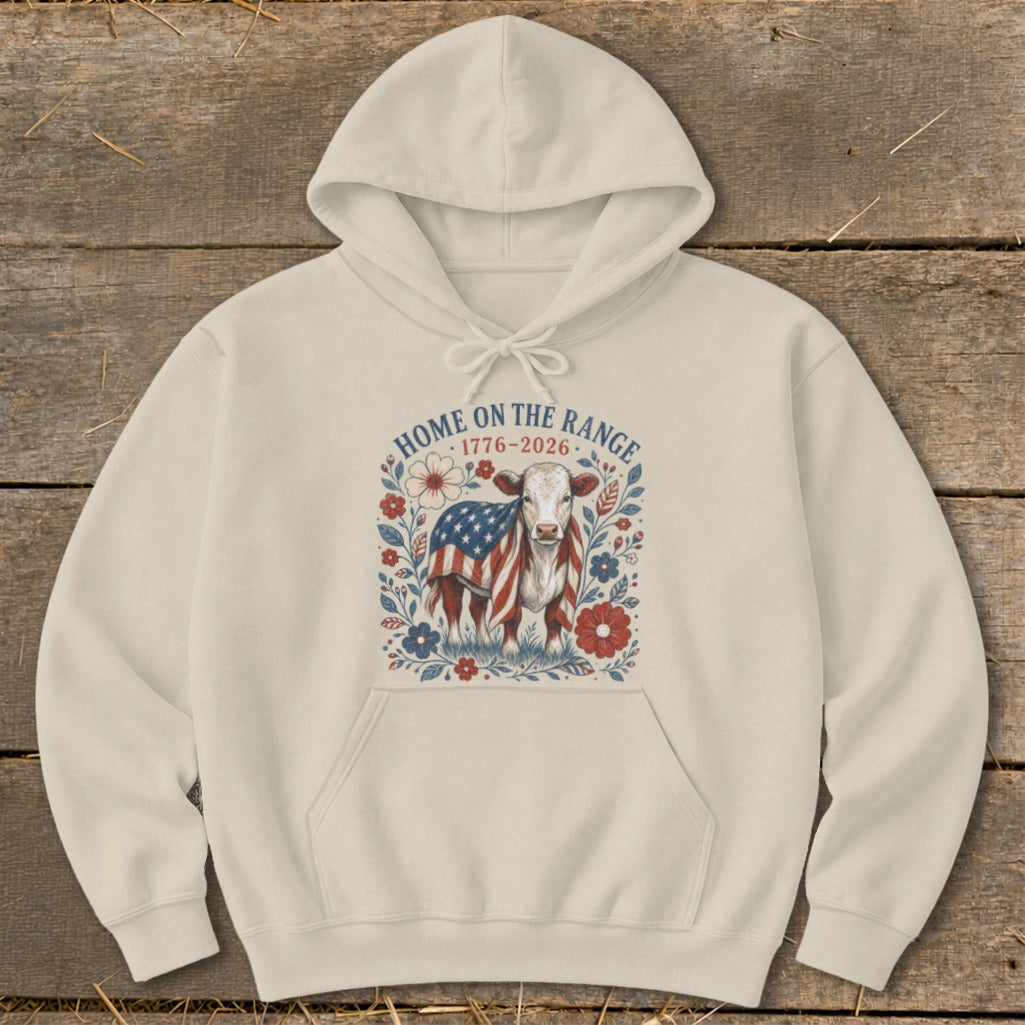 Cream hoodie with a cow and American flag graphic that reads "Home on the Range 1776-2026".