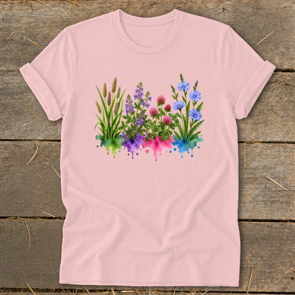 Light pink crewneck t-shirt featuring a watercolor graphic of four clusters of wildflowers over colorful paint splatters.