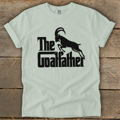 Light green t-shirt with black text and goat graphic saying "The Goatfather".