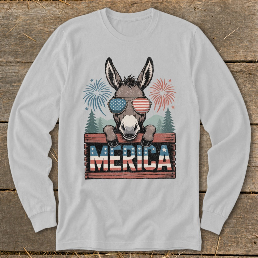 Donkey wearing American flag sunglasses behind "MERICA" sign with fireworks and trees.