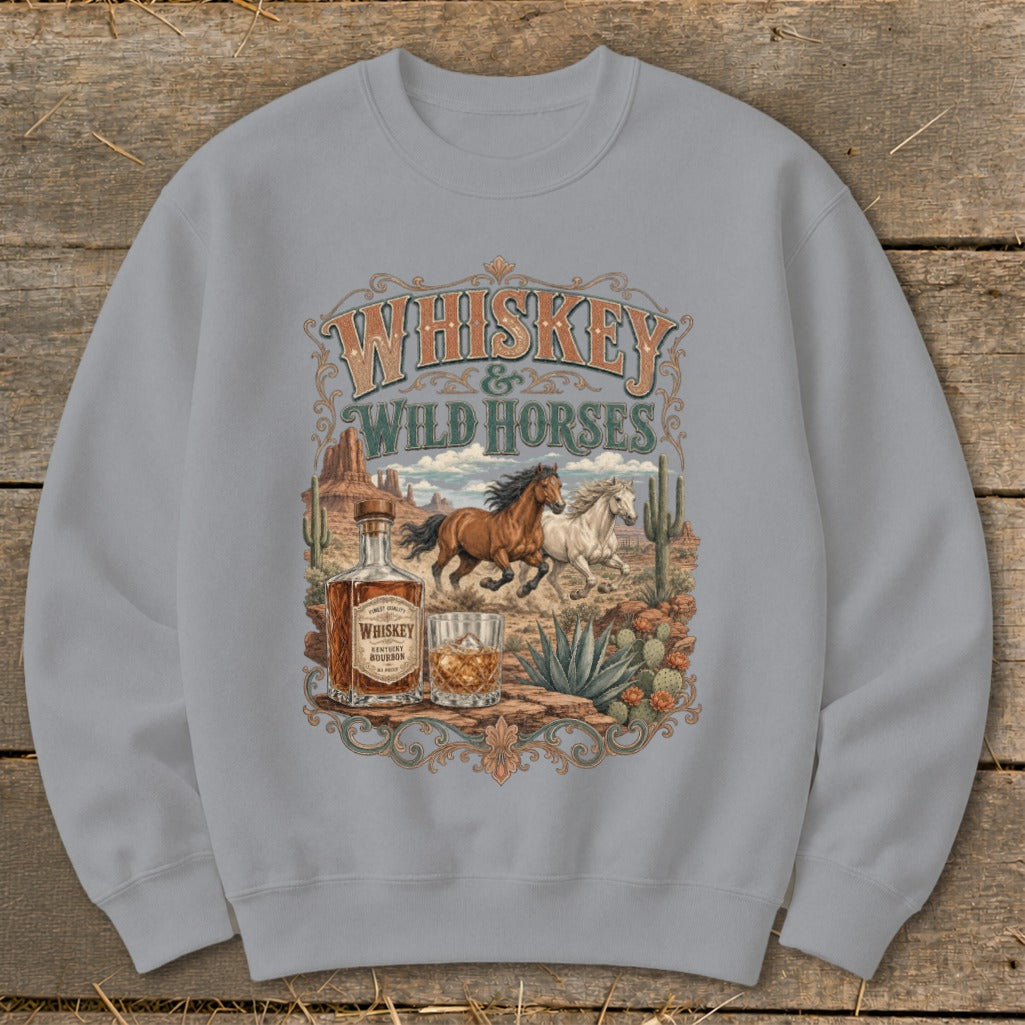 Whiskey & Wild Horses graphic on a gray sweatshirt with desert landscape.