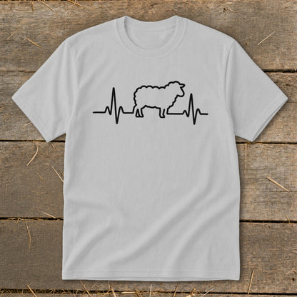 A light gray short-sleeve t-shirt with a black line-art graphic of a sheep integrated into a heartbeat monitor pulse on the chest.