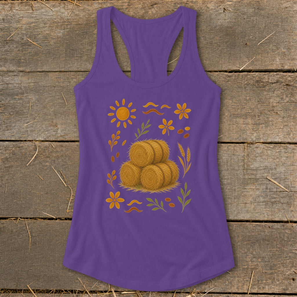 Purple tank top with a sun, hay bales, flowers, and leaves graphic.