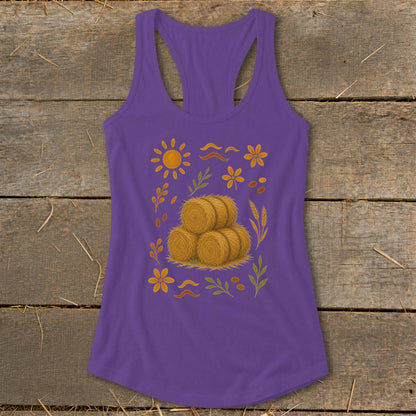 Purple tank top with a sun, hay bales, flowers, and leaves graphic.