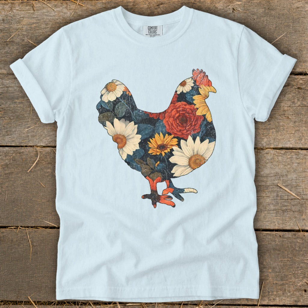 Light blue t-shirt featuring a chicken silhouette filled with colorful floral patterns.
