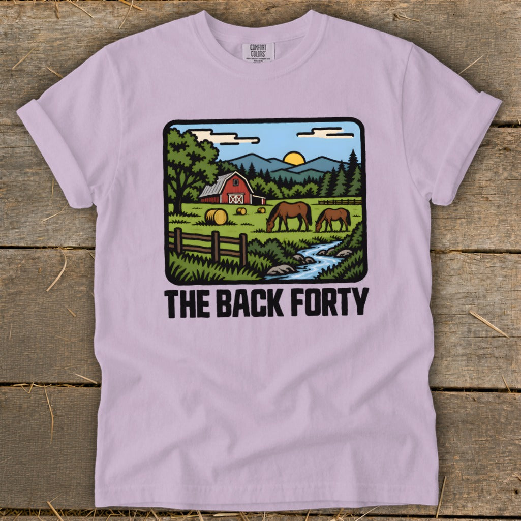 Light purple crewneck t-shirt featuring a cartoon rural landscape graphic and the text THE BACK FORTY.