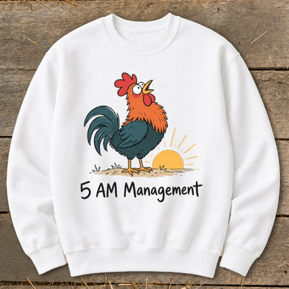 White sweatshirt with cartoon rooster and sunrise graphic with "5 AM Management" text.