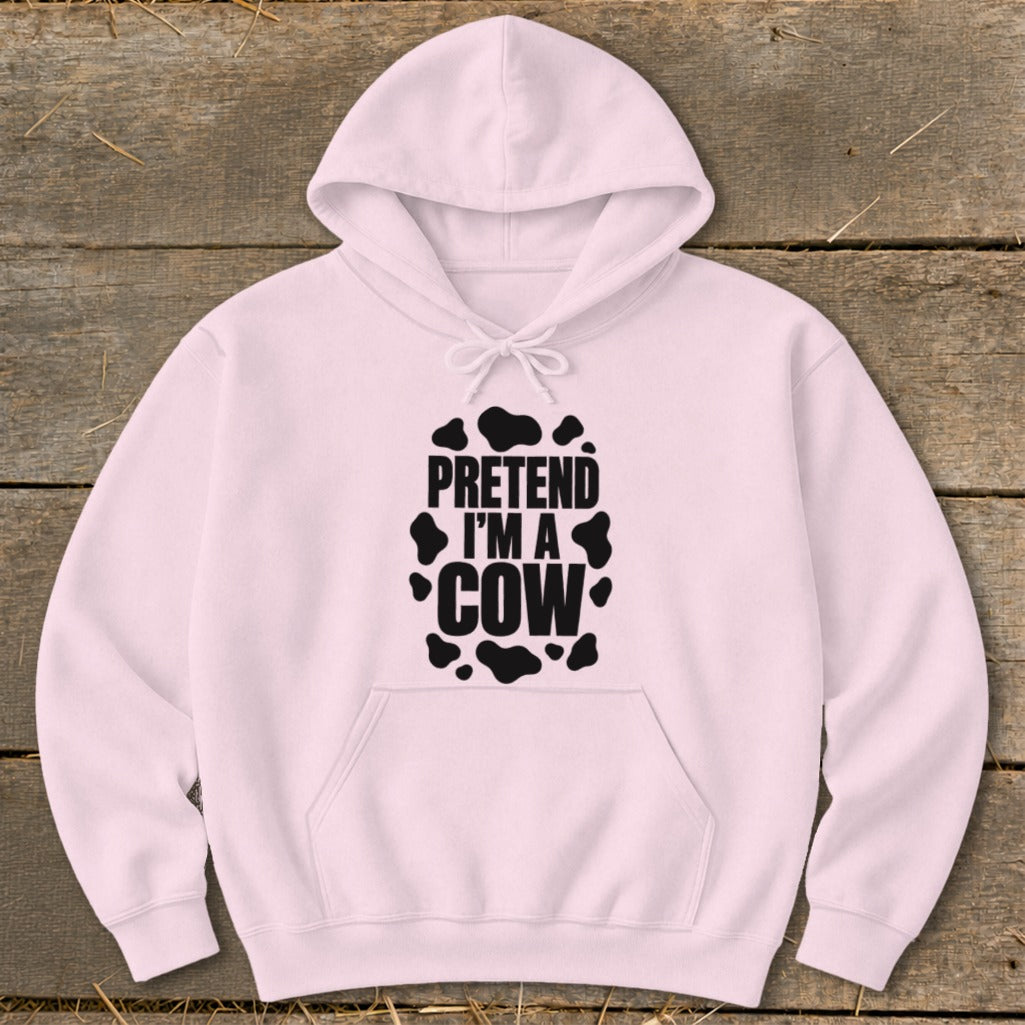 Pink hoodie with black text "PRETEND I'M A COW" and cow spots.