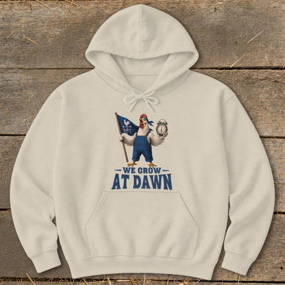 Cream hoodie with a rooster holding a flag and alarm clock, text reads "WE GROW AT DAWN".