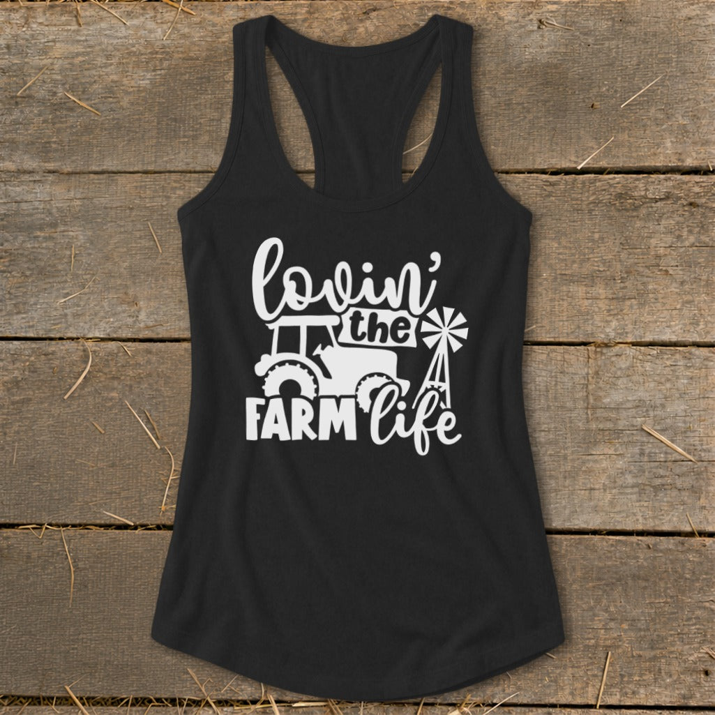 Black tank top with white graphic of a tractor, windmill, and "lovin' the farm life" text.