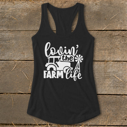 Black tank top with white graphic of a tractor, windmill, and "lovin' the farm life" text.