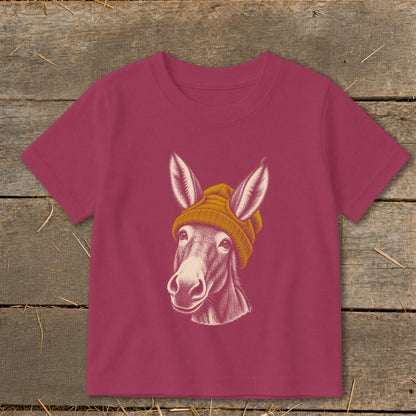 Donkey wearing a yellow beanie, graphic on a magenta t-shirt.