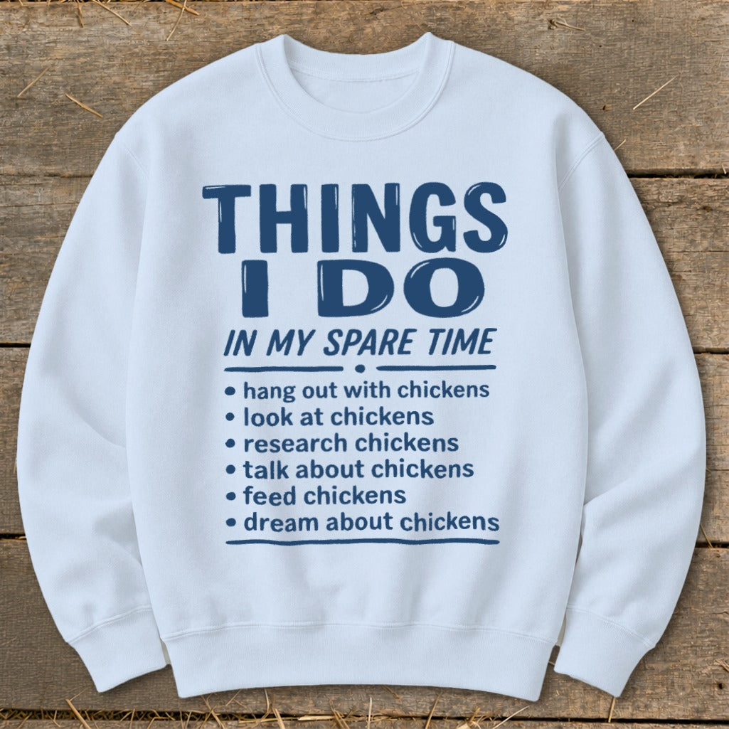 White sweatshirt with blue text "Things I Do In My Spare Time" and chicken-related activities.