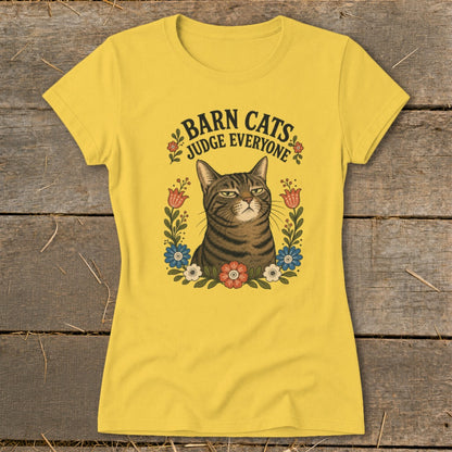 Yellow t-shirt with a tabby cat surrounded by flowers and text "Barn Cats Judge Everyone."